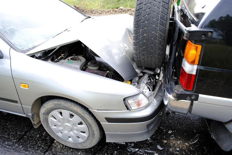 A car that has been hit by a truck.